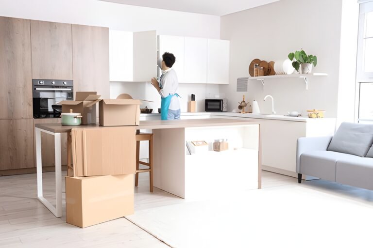 Cleaner organizing modern kitchen cabinets during professional move-in cleaning in Mississauga home